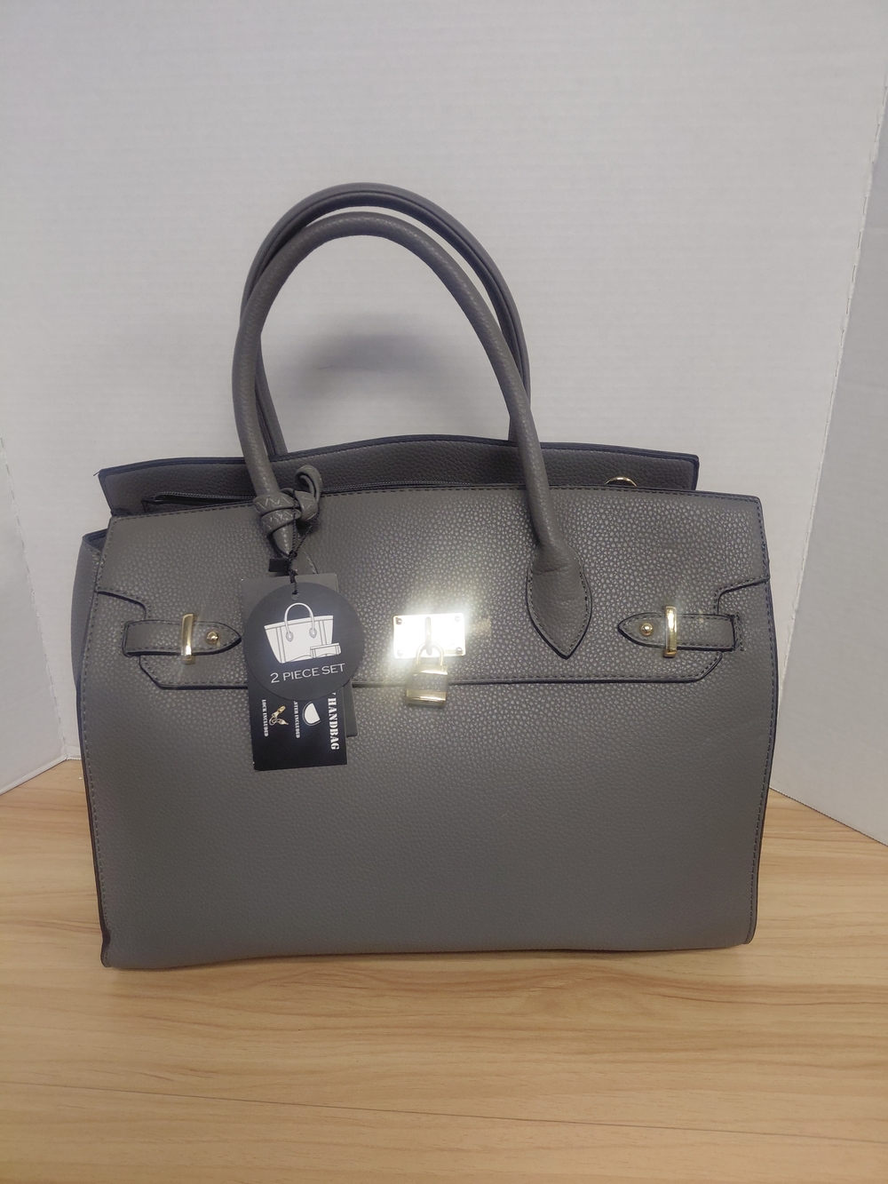 Grey leather handbag with concealed carry feature